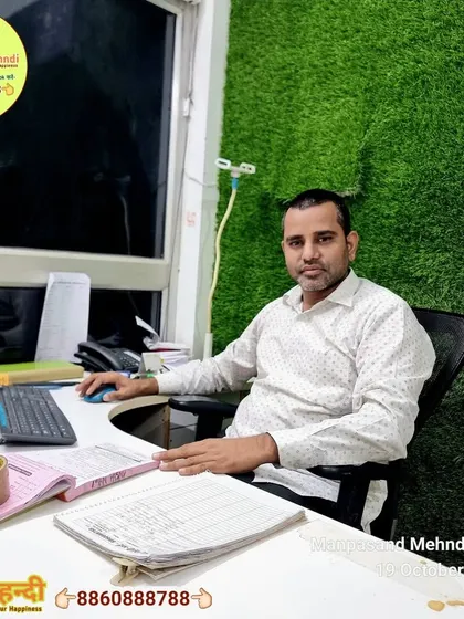 A photo of me, Rajkumar Nayak, at my desk, ready to manage your Karwa Chauth bookings.