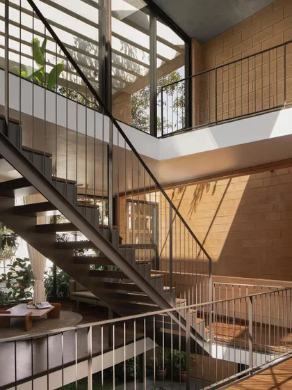 (Duplicate of 34) The central staircase acts as a sculptural element within the Debris Block House, connecting floors and creating dynamic diagonal views across the living spaces.