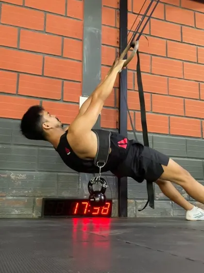 A weighted front lever row, another excellent exercise for building pulling strength and core stability.