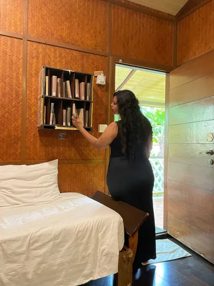 A guest browsing the in-room library, a small touch to make your stay more relaxing and enjoyable.