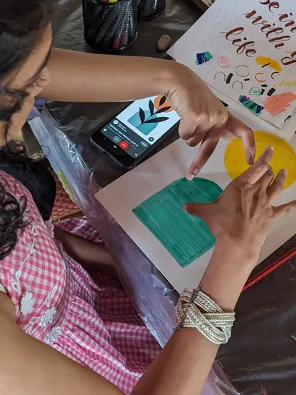 A participant working on a calligraphy project, carefully crafting each letter.