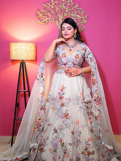 A full-length view of the white floral lehenga, showing its beautiful flow and intricate embroidery.