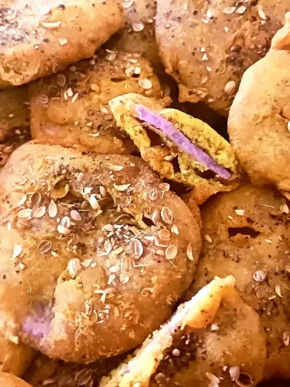 Ratalu Puri, a unique Gujarati pakora made with purple yam (ratalu), besan, and a sprinkle of coarse black pepper.