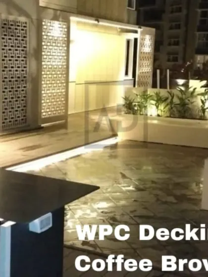 Another view of the coffee brown WPC decking project, showing how the integrated lighting strip follows the clean lines of the planters and seating, highlighting the layout of the space after dark.