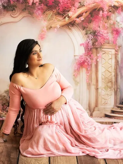 Looking away in a moment of reflection. This pose adds a sense of wonder and contemplation to the maternity gallery.