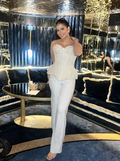 The full look, showing how the makeup and hair come together with her stylish outfit for a perfect anniversary celebration.