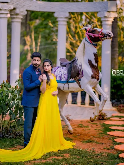 A dramatic and playful shot with a rearing horse. The couple's elegant attire and the powerful pose of the horse create a very striking image.