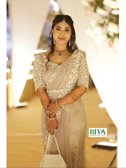 My client Greeshma looking absolutely stunning in her complete Sheer Series outfit. This full length view shows how the embellished saree, blouse, and belt come together to create a cohesive and graceful silhouette. The monotone shade allows the intricate pearl and sequin workmanship to truly shine.