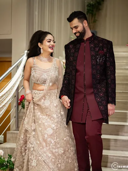 The couple's happy descent down the stairs, hand-in-hand. A perfect candid moment from their engagement.