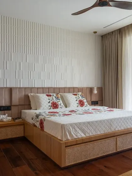 For the parents' bedroom, I aimed for a balance of warmth and artistic expression. A 3D patterned tile wall serves as a unique headboard, while the bed frame and side tables feature natural wood and cane for an earthy, tactile quality.