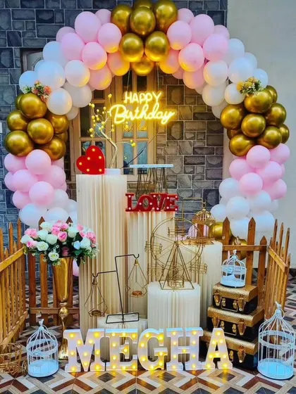 An outdoor birthday setup for 'Megha' in pink, white, and gold. This shows how our affordable packages can be adapted for different spaces.