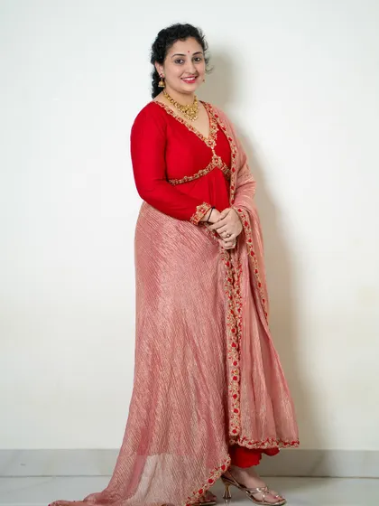 A rich red hand-embroidered Anarkali, a masterpiece of tradition and modern craftsmanship.