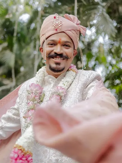 The groom's happiness shines through in this baraat portrait.