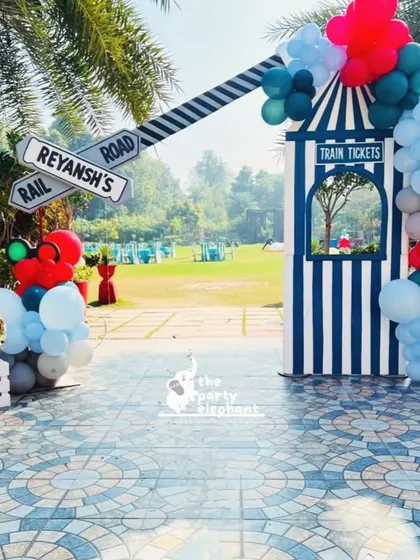 The entrance to the train party featured a ticket booth and a railway crossing sign, immediately immersing guests in the 'Birthday Express' theme as they arrived.