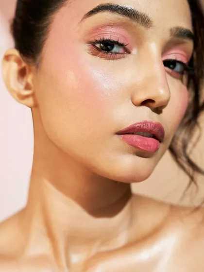 A closer look at the seamless blend of blush and highlighter. The skin looks radiant and healthy, a testament to Harpreet's hard work.