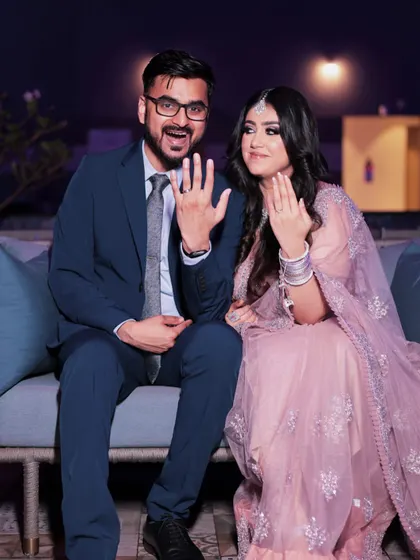 Showing off the rings. This happy couple's engagement photo captures the bride's soft, pretty makeup and her joyful smile.