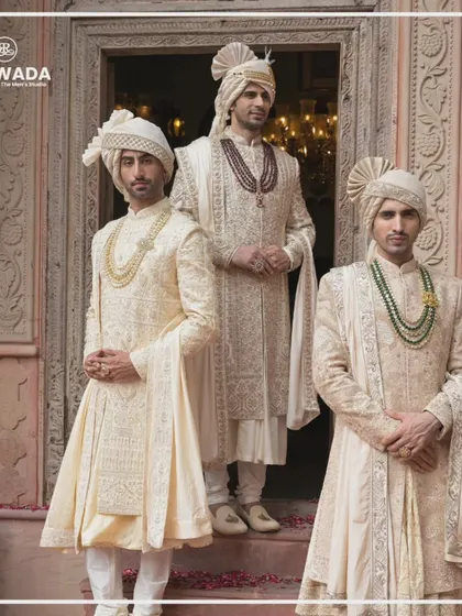 This image captures the regal presence of the Shauhar groom. The intricate embroidery and luxurious fabric of the sherwanis are designed to make a statement of timeless elegance.
