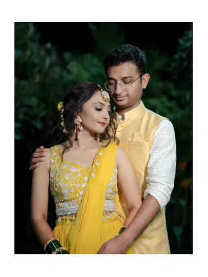 An intimate portrait of the couple from their Haldi or Sangeet ceremony, dressed in beautiful matching yellow outfits.