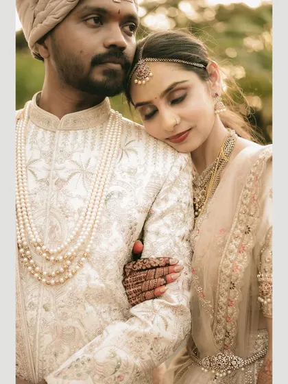 A quiet, intimate portrait of the bride resting her head on the groom's shoulder.