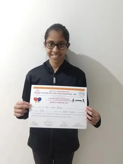 Kaira Baliga proudly displays her certificate after winning a bronze medal in the U-13 category at the Karnataka State Championship.