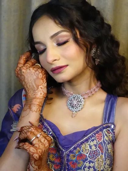 A close-up on the soft glam eye makeup and henna-adorned hands, capturing the complete essence of a pre-wedding bridal look.