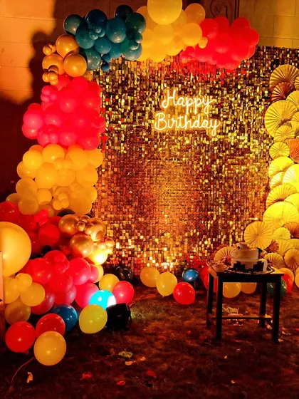 A closer look at the Winnie the Pooh themed birthday backdrop. The combination of the gold sequin panel, neon sign, and a classic Pooh bear cutout makes for a timeless and heartwarming party setting.