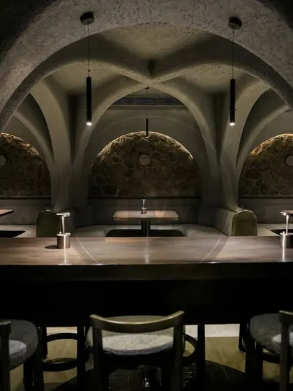 Another perspective of the dramatic, arched interiors of 'Call me Ten'. Our minimalist bar stools and tables are designed to complement, not compete with, the powerful architectural elements of the space.