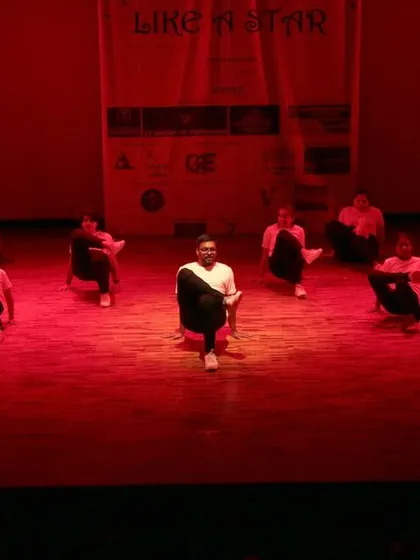 The group rises in unison during their contemporary performance.
