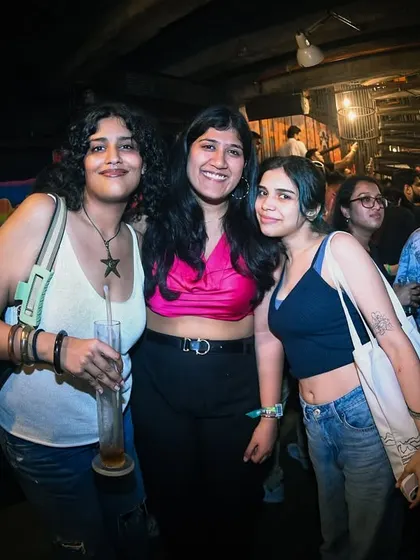 Friends posing for a picture, making memories at our event.