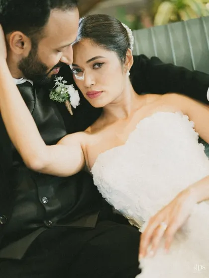 An artistic and moody portrait of the couple. The close-up, intimate pose and the bride's direct gaze create a stunning and memorable image.