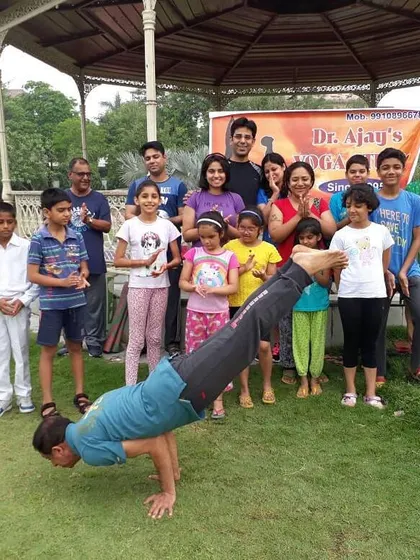 A proud moment demonstrating Mayurasana (Peacock Pose) surrounded by our wonderful students of all ages. This is what our community is all about: learning, growing, and smiling together.