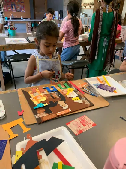 A young artist assembles her cubist-style collage, learning how Picasso played with perspective and form.