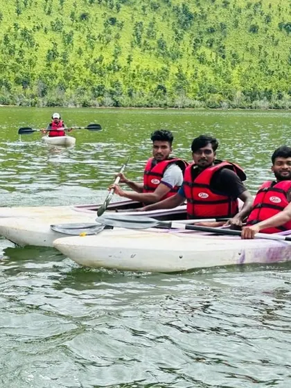 Participants in sit-on-top kayaks take a break on the water, enjoying the calm and scenic environment.