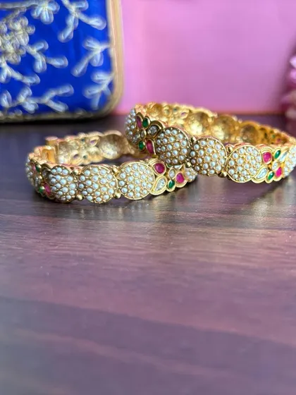 Another view of the pearl bangles, showing the fine detailing on the side.