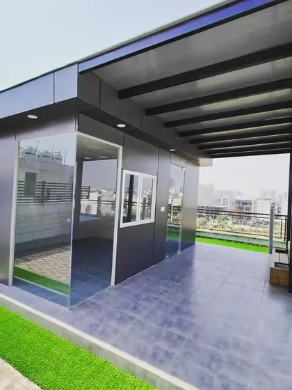 This design features a prefab room with an extended covered veranda, providing a shaded outdoor space that connects directly to the indoor area.