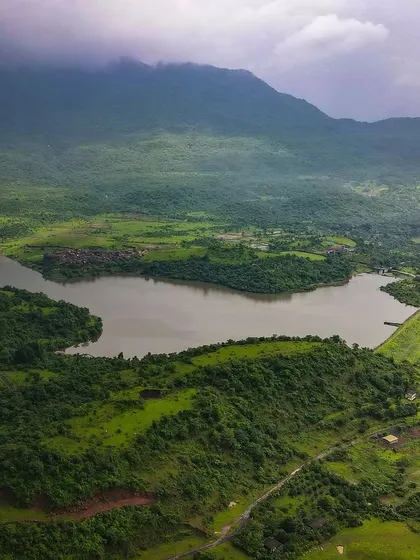 Are you missing Badlapur’s Monsoon? A beautiful aerial shot of the landscape around Kondeshwar, with the lake and the green hills under a cloudy sky.