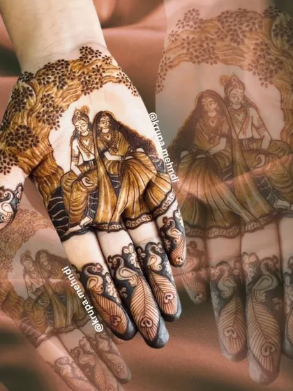 An ethereal portrait of Radha and Krishna sitting together, a timeless symbol of divine love. This is a popular and meaningful choice for bridal mehndi.