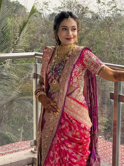 Another angle of the bride on the balcony, showing her beautiful saree and jewellery.
