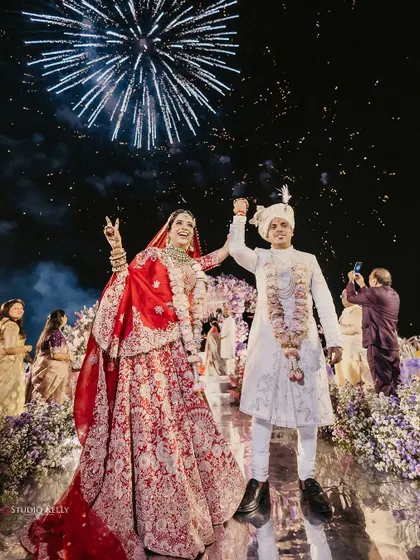 A moment of pure, unadulterated joy as the couple celebrates with fireworks after their ceremony.
