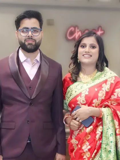 A well-dressed couple posing for a portrait at an evening function.