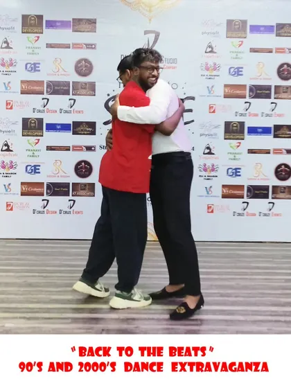 A congratulatory hug for a winner at the "Back to the Beats" event.
