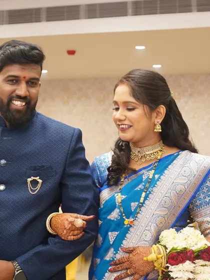 A happy couple making their entrance. The bride's makeup is designed to be radiant and photo-ready for all the big moments of the reception.