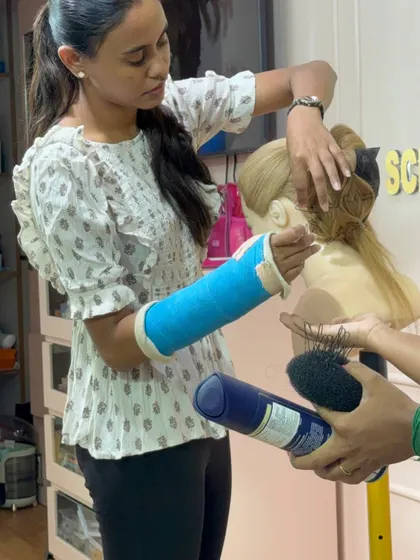 Our trainer demonstrating a technique with precision, even while managing an injury. Her dedication is an inspiration to us all.