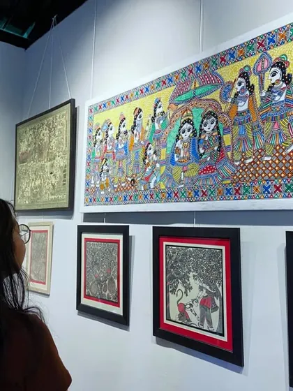 Students observing intricate Madhubani paintings during their visit to Craft Village, learning about the storytelling aspect of traditional Indian art.