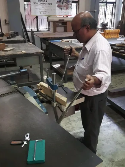 An instructor demonstrates the setup and operation of a mortising machine, a critical skill for anyone serious about solid wood furniture construction.