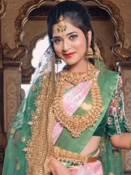 A model posing with a sheer veil, adding a touch of modern elegance to the traditional look.