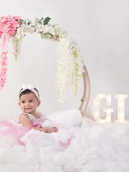 A personalized first birthday setup for Gia. The light-up letters add a special touch, making the celebration all about her.