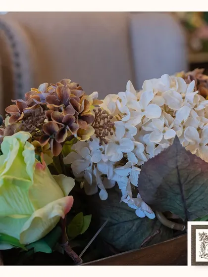 A detailed shot of the white and brown hydrangeas in the centerpiece, highlighting the subtle color variations that make the arrangement look so realistic.
