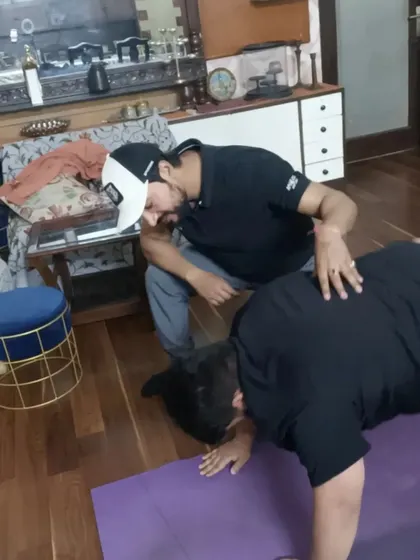 I bring the training to your doorstep. Here, I'm correcting a client's form during a bodyweight exercise in the comfort of their home in Indirapuram.