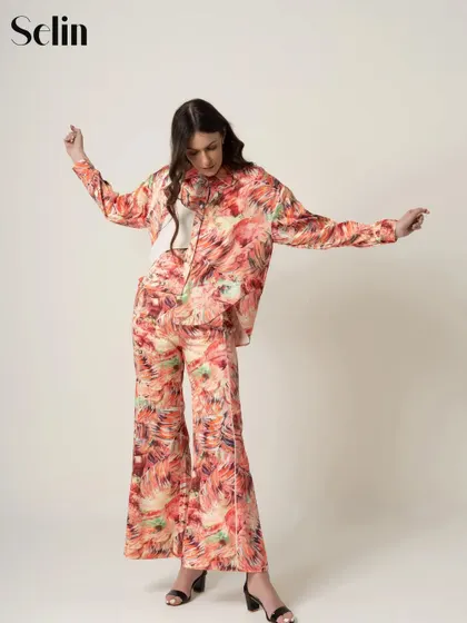 A full-page feature in Selin Magazine from a studio fashion shoot. This image showcases a vibrant, printed co-ord set with a sense of movement and style.
